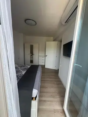 a bedroom with a bed and a sliding glass door at Sandanski escape in Sandanski