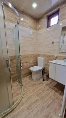 a bathroom with a shower and a toilet and a sink at Апартамент Недялкови II in Sandanski