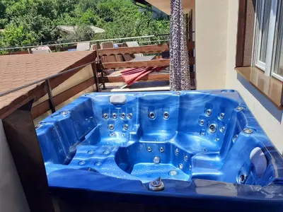 a blue bath tub sitting on top of a balcony at Sokol i Kalina spa in Pchelin