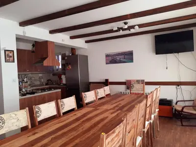 a kitchen with a long wooden table and chairs at Sokol i Kalina spa in Pchelin