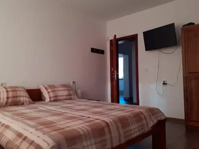 a bedroom with a bed and a flat screen tv at Sokol i Kalina spa in Pchelin
