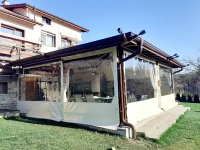 a building with a covering on the grass at Kalina i Sokol spa in Pchelin