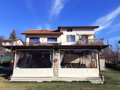 a house with a wrap around porch on top at Kalina i Sokol spa in Pchelin