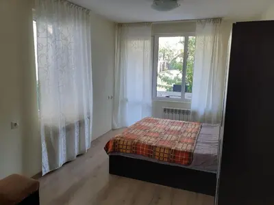 a bedroom with a bed and a window at Easy rooms in Sapareva Banya