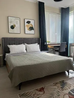 a bedroom with a large bed and a table at EL apartment in Sofia