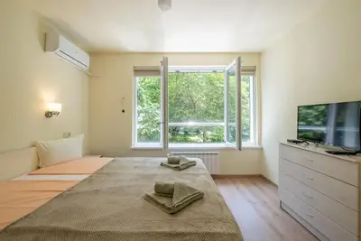 a bedroom with a large bed and a large window at Top Location, Brand New 3 BDRM Apt & Free parking in Sofia