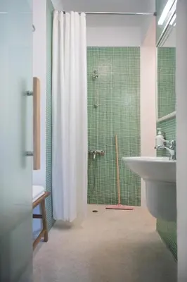 a bathroom with a shower curtain and a sink at Dazzling Minimalist One Bedroom Apartment in Sofia