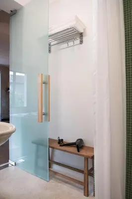 a bathroom with a glass shower and a sink at Dazzling Minimalist One Bedroom Apartment in Sofia