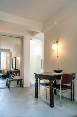 a living room with a table and chairs at Dazzling Minimalist One Bedroom Apartment in Sofia
