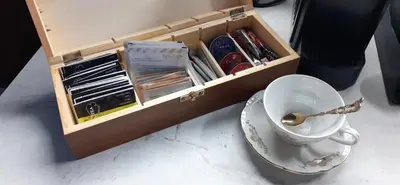 a cup and saucer next to a wooden box at Alex Place-Central Sofia in Sofia