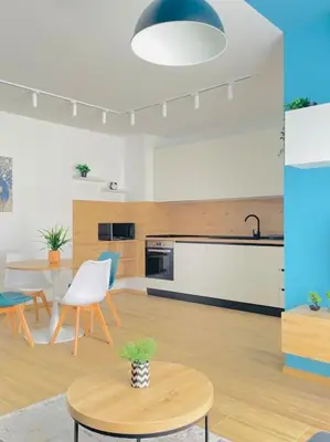 a living room with a kitchen and a table at Luxurious apartment 1BDR by Top Kvartiri Ltd in Sofia