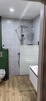 a bathroom with a shower and a toilet and a sink at Apartmenthaus Oborishte - 31 in Panagyurishte