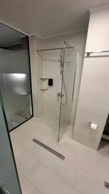 a shower with a glass door in a bathroom at RCR Einstein studios 2 in Sofia
