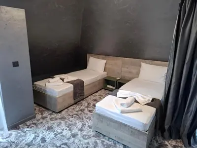 two twin beds in a room withskirts at RCR Einstein studios 2 in Sofia