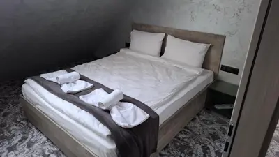 a bedroom with a bed with towels on it at RCR Einstein studios 2 in Sofia