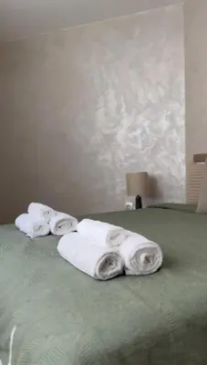 a group of towels sitting on top of a bed at Славянска резиденс - Спокойствие в центъра на Пловдив in Plovdiv