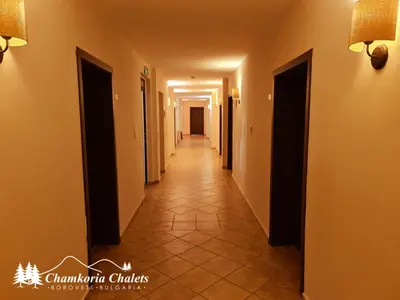 a hallway of a building with a long corridor at Chamkoria Chalets 409 in Borovets