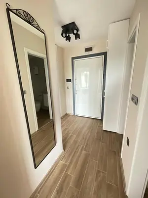 a hallway with a large mirror and a bathroom at Modern 1BR Apart FREE Parking with Hill View in Plovdiv