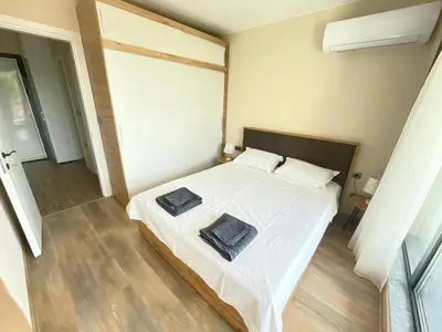 a bedroom with a white bed with two pillows on it at Modern 1BR Apart FREE Parking with Hill View in Plovdiv