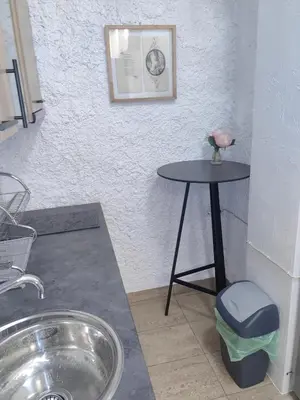 a small table in a room with a table with a flower on it at Graf Ignatiev 27 in Sofia