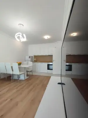 a kitchen with a table and chairs and a dining room at Stylish apartment Zingara 2 in Sofia
