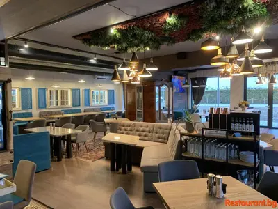 a restaurant with couches and tables and chairs at Stylish apartment Zingara 2 in Sofia