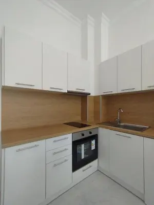 a kitchen with white cabinets and a sink at Stylish apartment Zingara 2 in Sofia