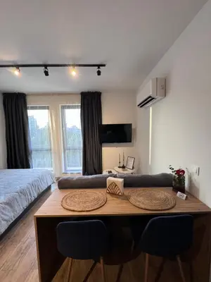 a room with a bed and a table with chairs at Studio AUREA in Sofia
