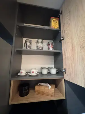 a cupboard with a bunch of dishes in it at Studio AUREA in Sofia