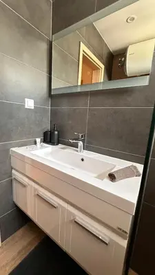 a bathroom with a white sink and a mirror at Studio AUREA in Sofia