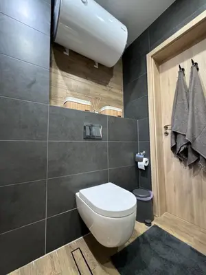 a bathroom with a white toilet in a room at Studio AUREA in Sofia