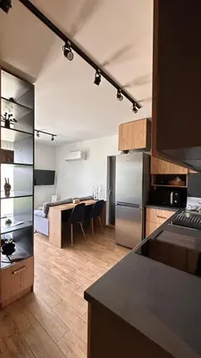 a kitchen with a refrigerator and a table in it at Studio AUREA in Sofia