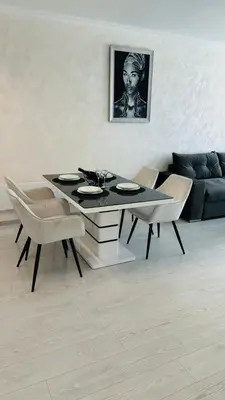 a dining table and chairs in a living room at Danielis Apartament in Velingrad