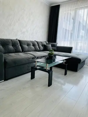 a living room with a couch and a coffee table at Danielis Apartament in Velingrad