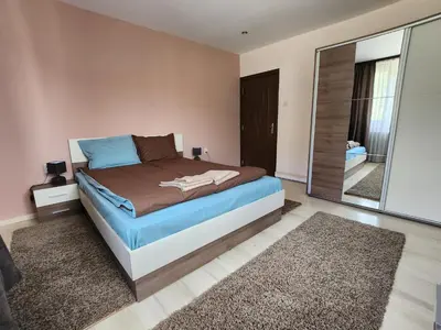 a bedroom with a bed and a large mirror at Къща за гости ЕВА in Madzhare