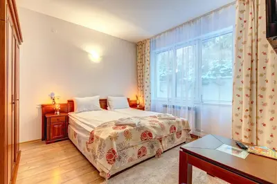 a bedroom with a bed and a large window at MyPlace Pamporovo 2 in Pamporovo