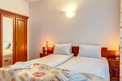 a bedroom with two beds and a mirror at MyPlace Pamporovo 2 in Pamporovo