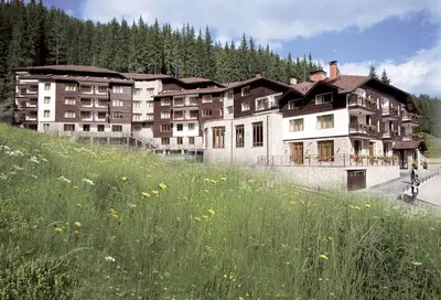 a large building on the side of a hill at MyPlace Pamporovo 2 in Pamporovo