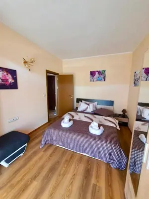 a bedroom with a large bed in a room at Апартаменти Лили in Devin