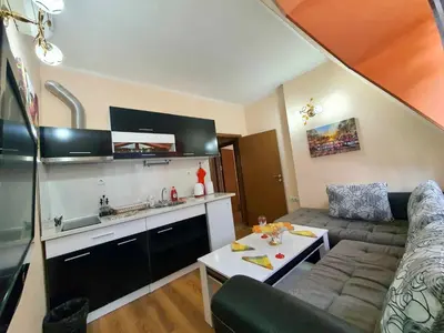 a living room with a couch and a table at Апартаменти Лили in Devin