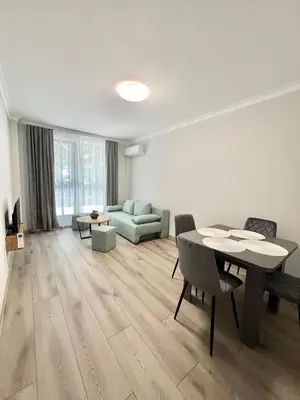 a living room with a table and a couch at GREEN PARK Apartments and rooms for guests in Asenovgrad