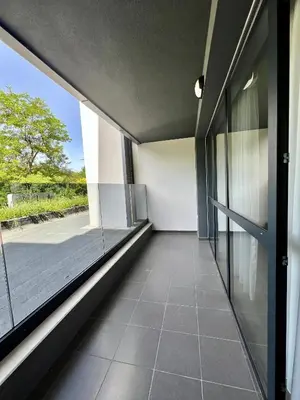 an empty hallway with large glass windows in a building at GREEN PARK Apartments and rooms for guests in Asenovgrad