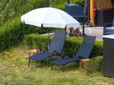 two chairs and an umbrella in the grass at Kostenets Hills in Kostenets Village