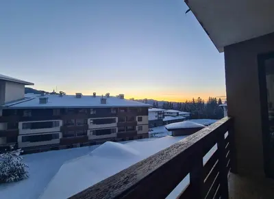 a balcony with snow on the roof of a building at Saphir apartment , Rhodopi Pearl Pamporovo in Pamporovo