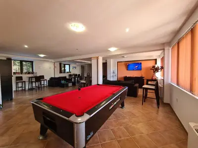 a pool table in the middle of a living room at Saphir apartment , Rhodopi Pearl Pamporovo in Pamporovo