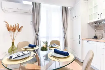 a dining room with a glass table and chairs at Lyana's One Bedroom apartment in Bansko