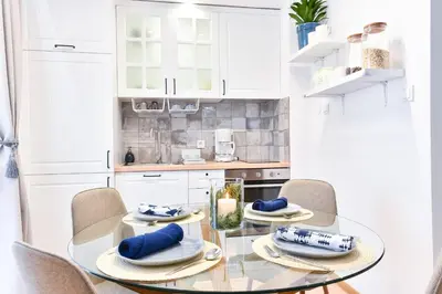 a dining room with a glass table and chairs at Lyana's One Bedroom apartment in Bansko