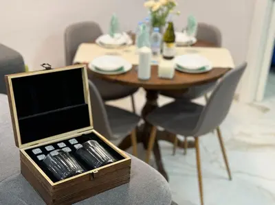 a wooden box sitting on a chair with a dining table at Modern Vitosha Maisonette with Garage in Sofia