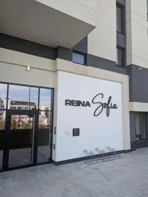 a facade of a building with a sign on it at Reina Apartment- next to Sofia zoo and close to Mall Paradise in Sofia