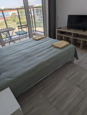a bedroom with a bed with two towels on it at Reina Apartment- next to Sofia zoo and close to Mall Paradise in Sofia